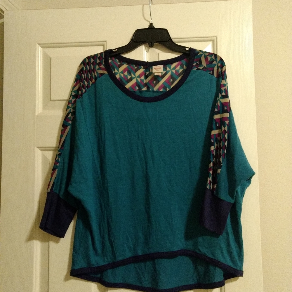 Half sleeve top. Blue with geometric design.
